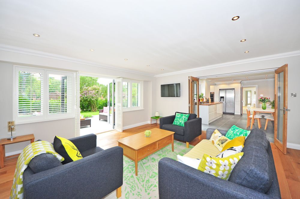 An open-plan living and kitchen space opening to a garden