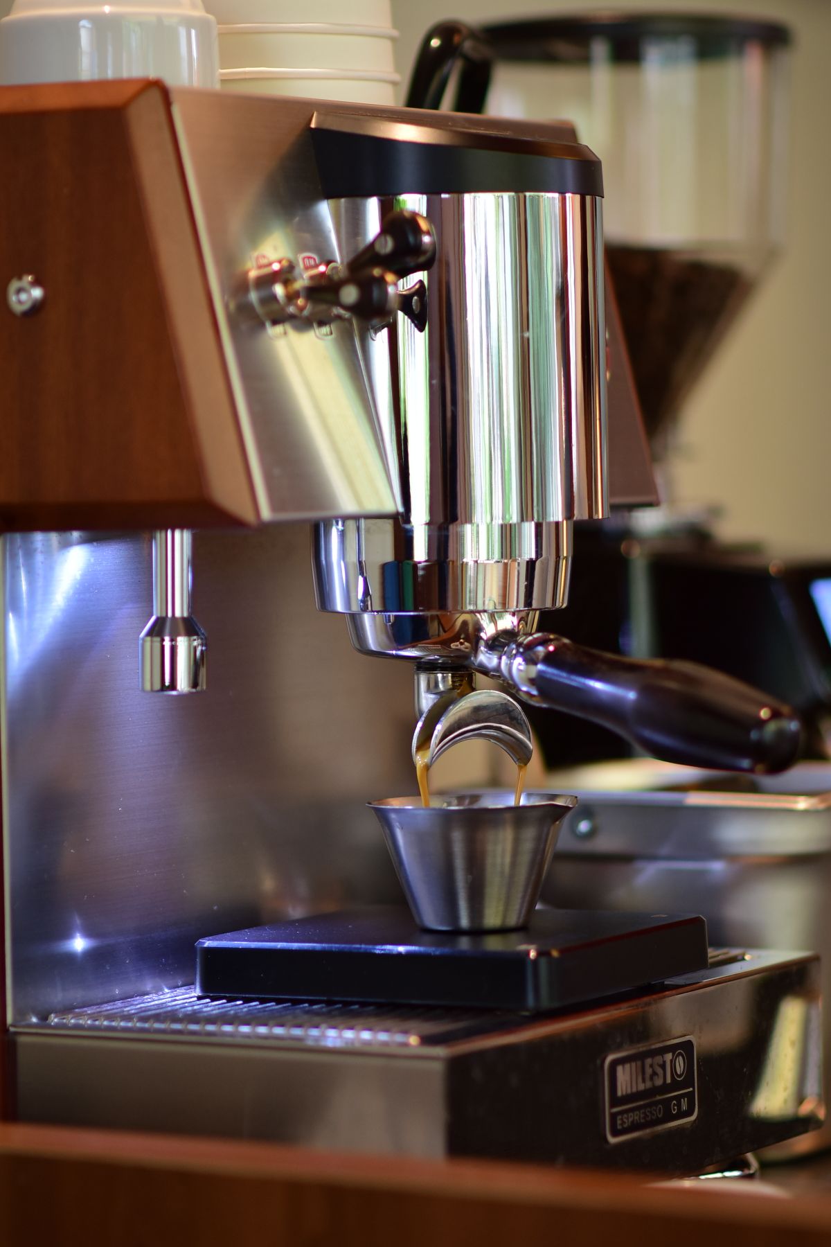 Espresso running from the portafilter into a cup