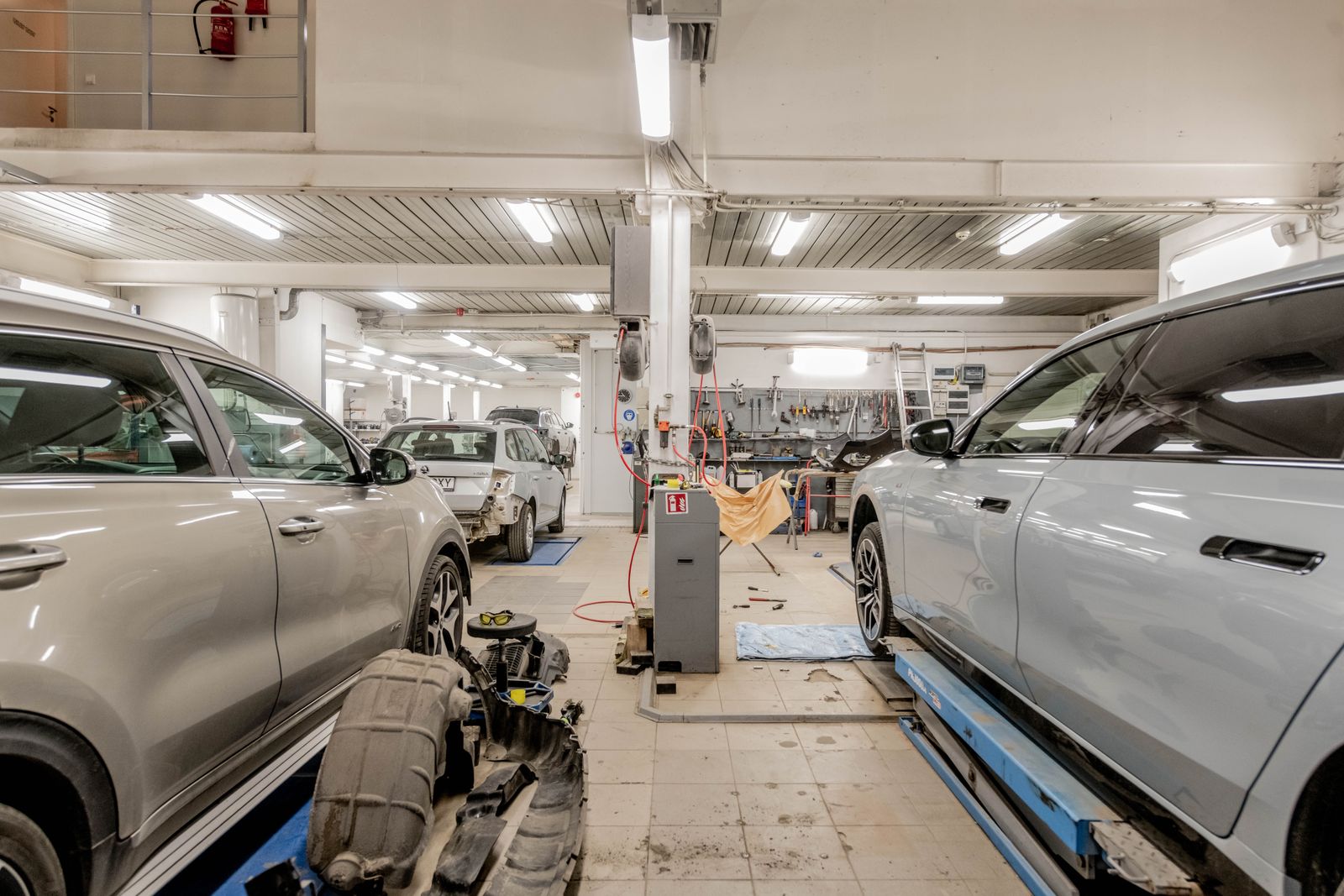 Inside the service bays: cars on lifts, tool chests and equipment along the wall