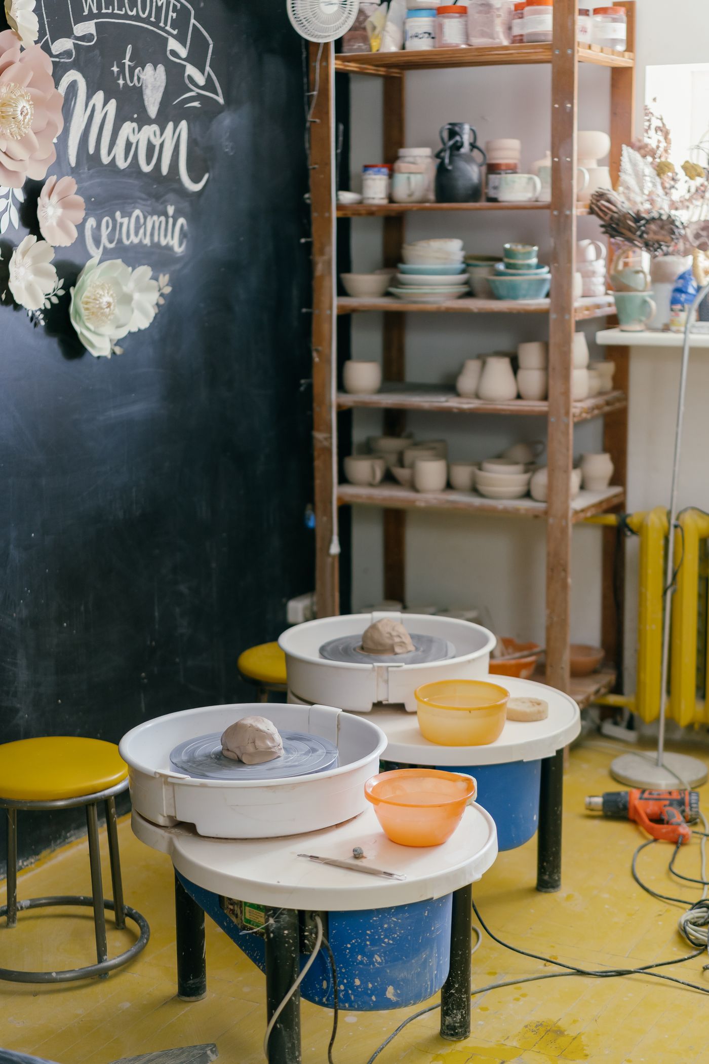 Stacked plates and bowls waiting on a shelf in the pottery