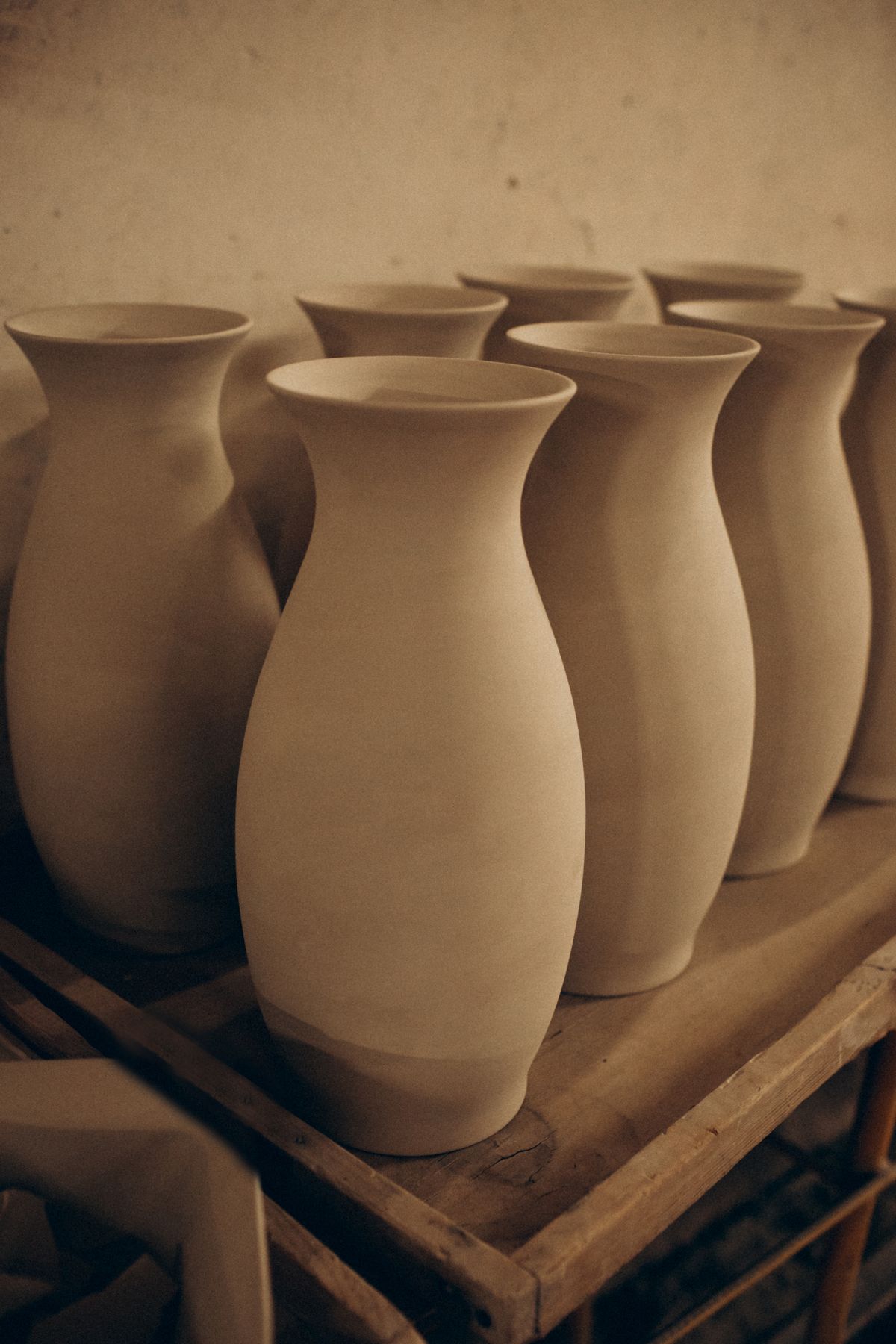 Handmade ceramic vases grouped on a workbench