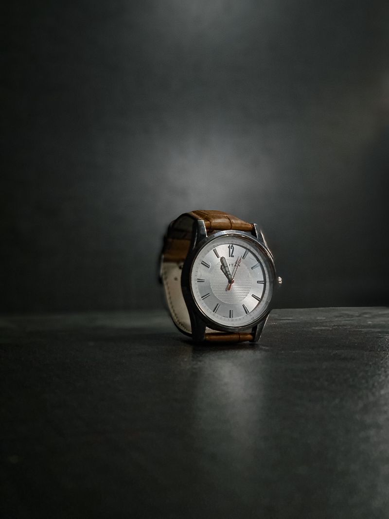 Universal Genève Polerouter on a brown leather strap, silver crosshair dial lit from one side against a dark ground