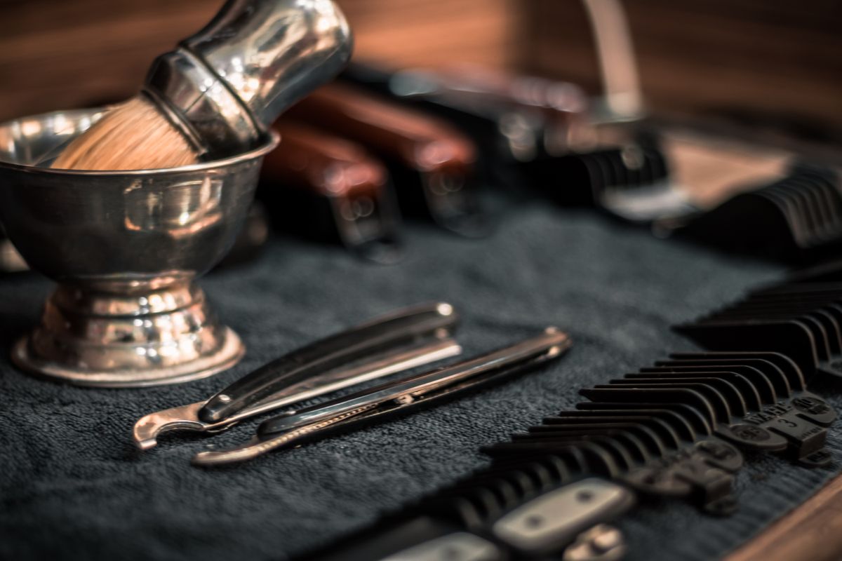 Razors, combs and shears laid out on the barber's counter