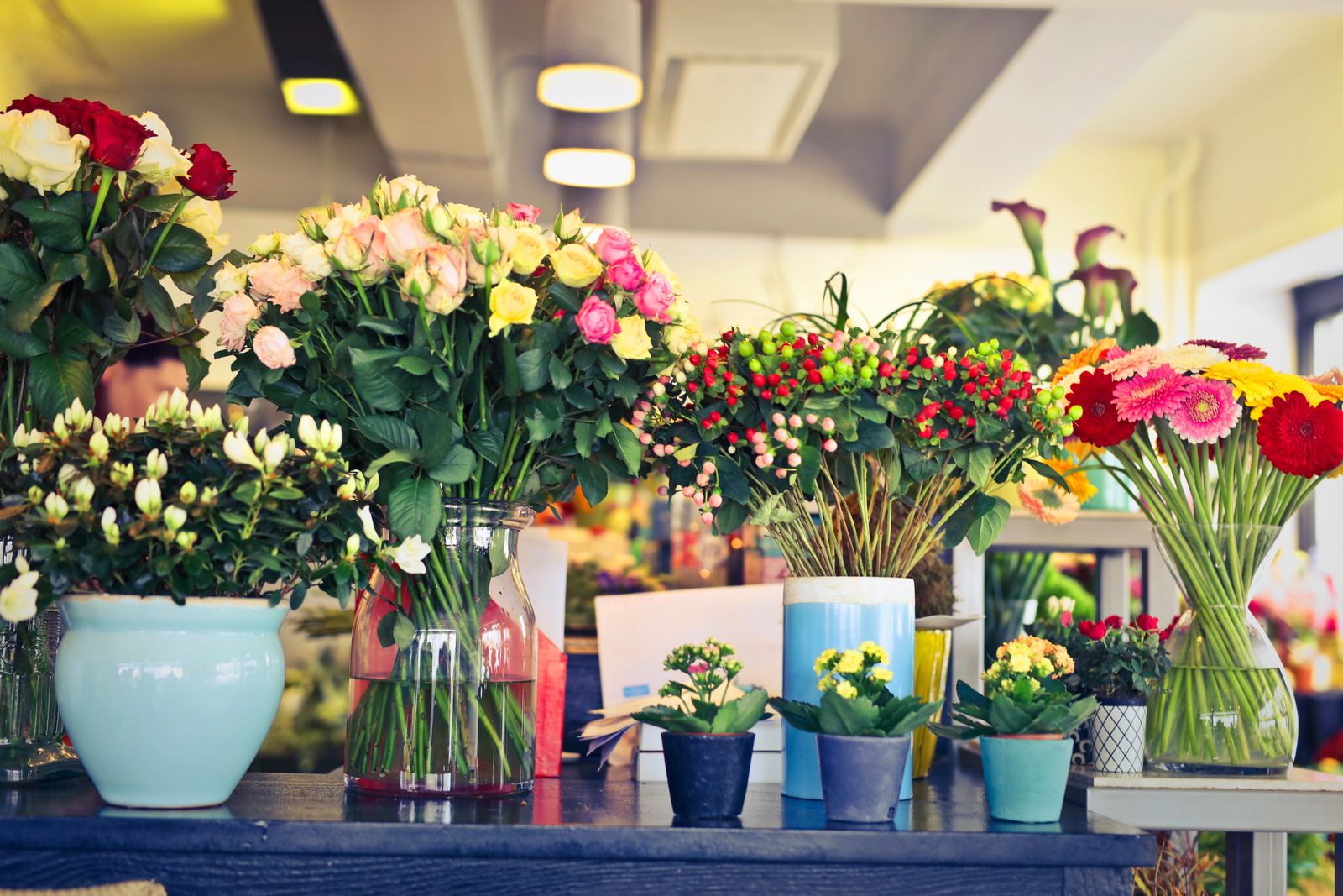 Buckets of cut flowers filling the shop, arrangements ready on the counter