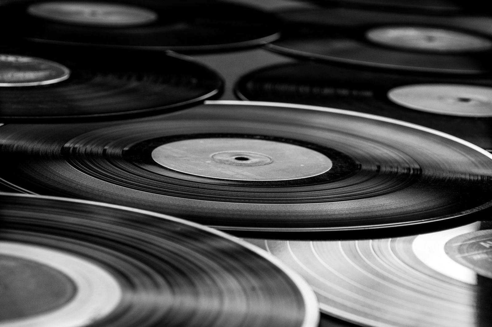 Vinyl records stacked and fanned out, shot in black and white
