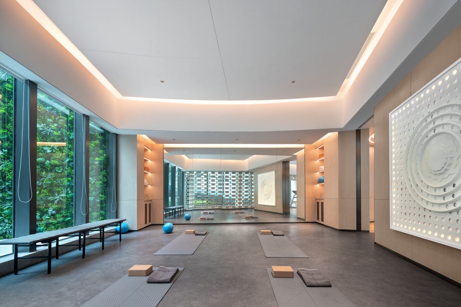 The practice room: bare wood floor, high windows and mats laid out