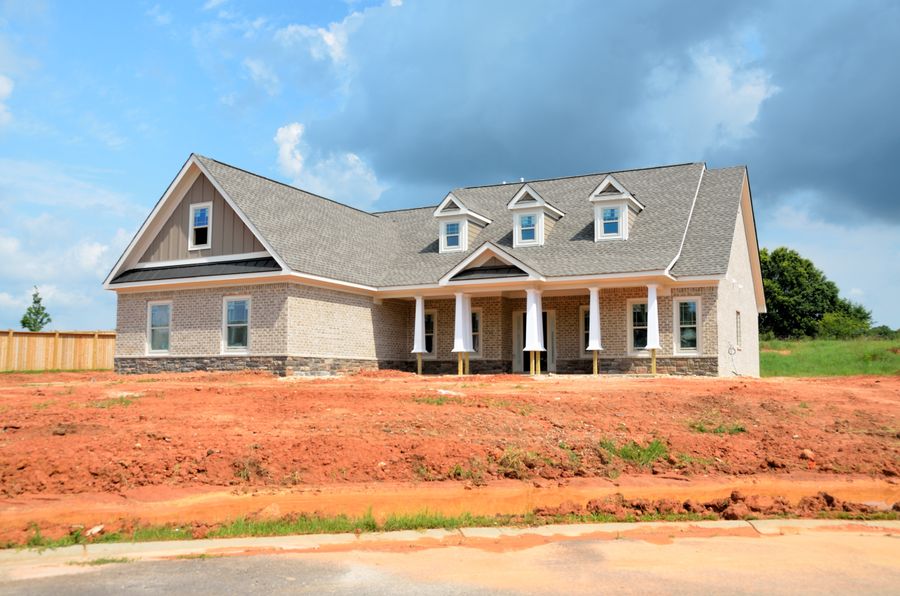 A farmhouse with a wrapped porch